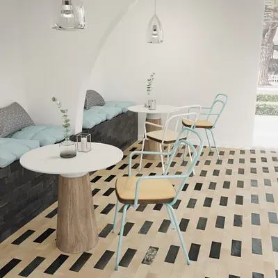 Restaurant banquette above a bejmat floor scattered with black and green tiles