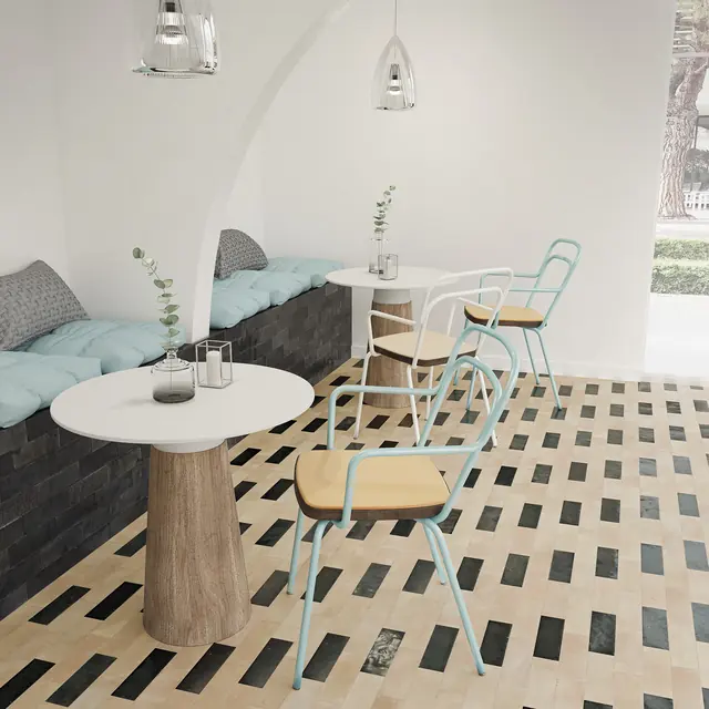 A bejmat floor with scattered coloured tiles running beneath a banquette and a low table