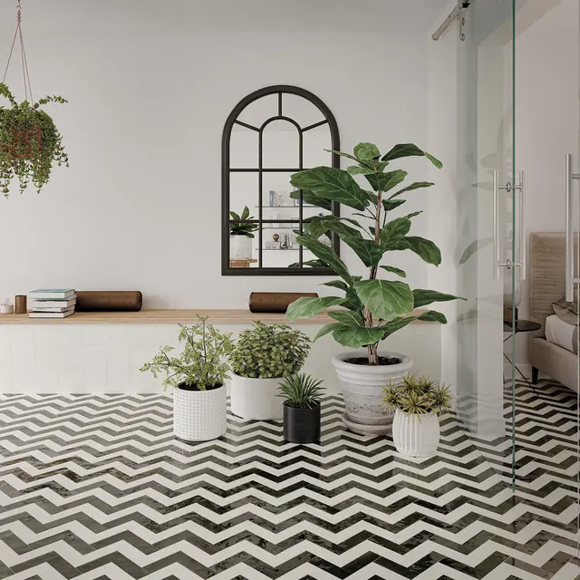 A black and white bejmat floor laid as a chevron, the tiles meeting point to point in continuous lines