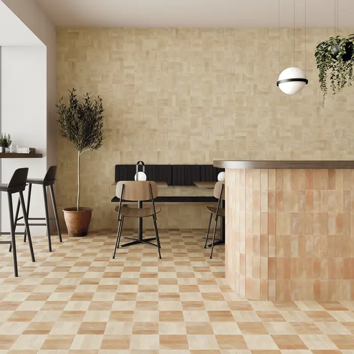 Sand-toned bejmat covering a caf&eacute; wall and counter front above a chequered terracotta floor