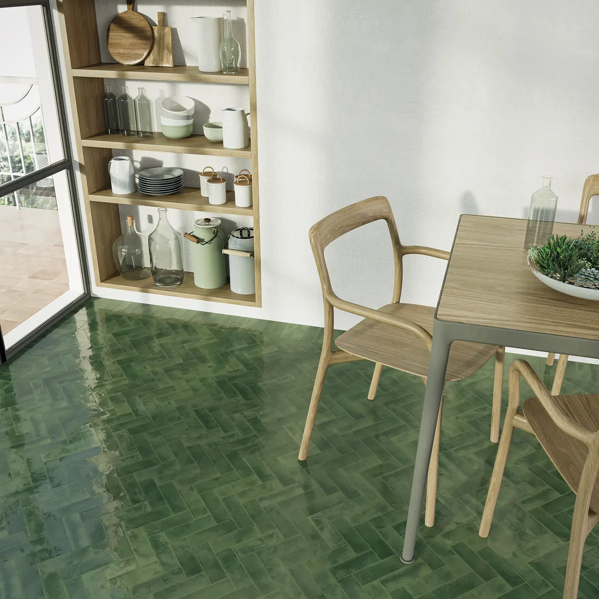 A deep green glazed bejmat floor running beneath a dining table and chairs