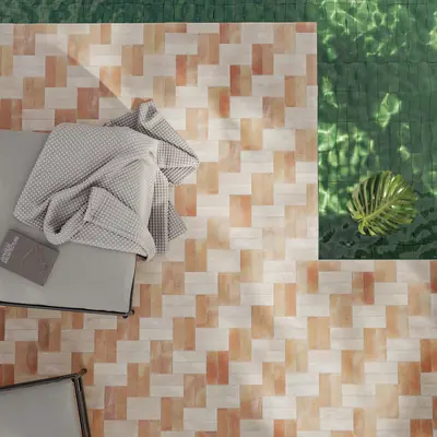 Flat lay of terracotta, white and green bejmat tiles with folded towels