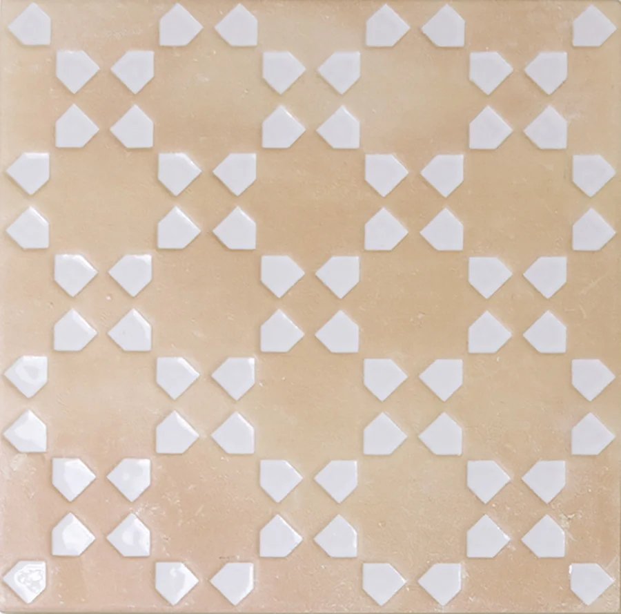 Pale sand bejmat tile with a repeating geometric motif inlaid in white