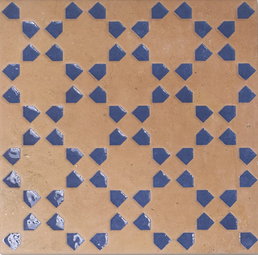 Bejmat terracotta tile with a repeating geometric motif inlaid in blue