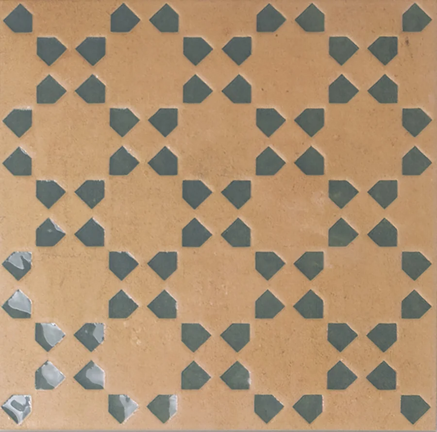Bejmat terracotta tile with a repeating geometric motif inlaid in green