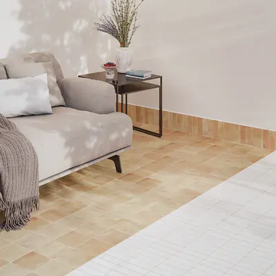 Sofa on a sand bejmat floor with a matching bejmat skirting run
