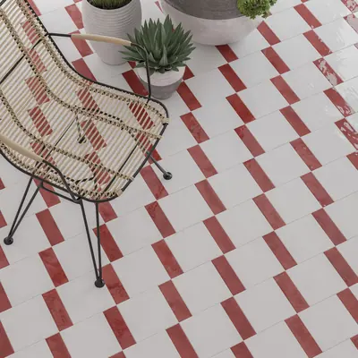 White bejmat floor with red tiles set through it in a regular dash pattern
