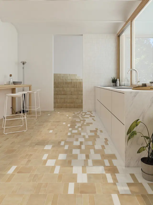 A pale bejmat kitchen floor with coloured tiles scattered through the field at a low density