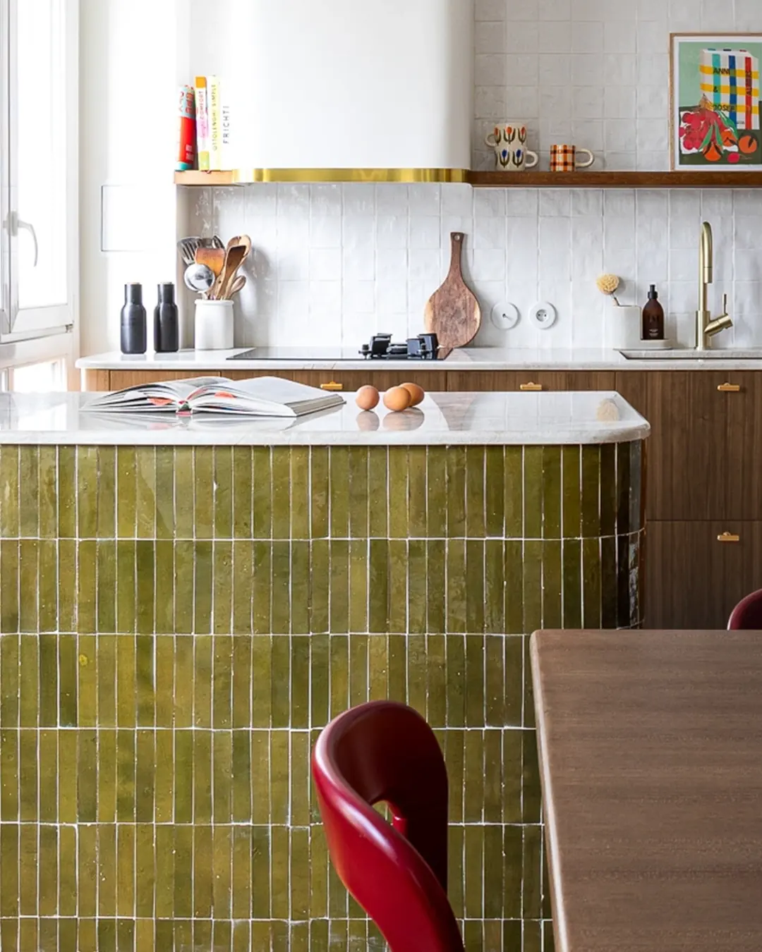 Olive green rectangular zellige tiles stacked in straight courses across a kitchen island front